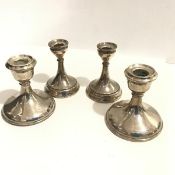 A pair of modern Birmingham silver desk style candlesticks, raised on tapered splay columns and