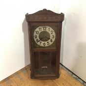 A German Hac Vienna style wall clock, mid 20thc., the arched cornice with carved geometric