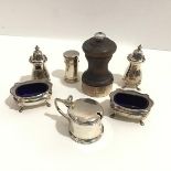 A treen Birmingham silver mounted pepper mill, a four piece Birmingham silver condiment set complete