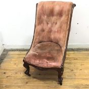 A Victorian nursing chair, the scroll carved back with buttoned upholstery over an upholstered seat,