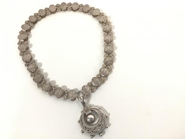 A 19thc open oval link engraved chain necklace with an engraved circular ball pattern edge pendant