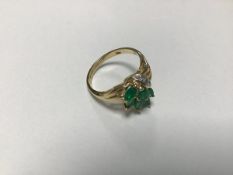 A 9ct gold emerald and diamond set cluster ring with six marquise cut emeralds and three brilliant