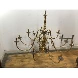 A brass pendant chandelier in the Dutch 18thc taste with eleven scrolling branches issuing from a