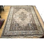 A Persian style carpet, the putty field with central medallion enclosed by tear shaped spandrels,