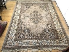 A Persian style carpet, the putty field with central medallion enclosed by tear shaped spandrels,