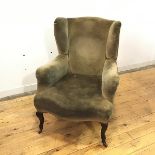 A late 19thc wing armchair, upholstered in a pale green velvet fabric, raised on cabriole legs