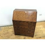 A George II style walnut fall front bureau, c.mid 20thc., the rectangular crossbanded top