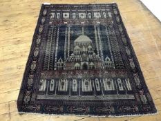 A Kirman prayer rug, the central indigo field with depiction of a mosque within ivory indigo and