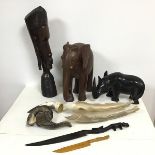 A hardwood carved bust of an African Woman (h.48cm), a hardwood elephant and rhinoceros, three