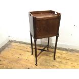 An early 20thc mahogany pot cupboard, the raised three quarter gallery incorporating a pair of