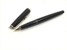 A Montblanc black fountain pen with stylised white flower mount to cap, complete with gold Montblanc