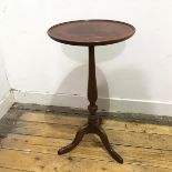 An early 20thc wine table, with a mahogany dished top with inset leather panel, on a turned oak