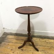 An early 20thc wine table, with a mahogany dished top with inset leather panel, on a turned oak