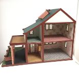 A 1970s doll's house complete with wallpapered interior, carpet, hanging cupboard, mirror, bed