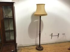 A mid 20thc floor lamp, with turned stem on circular base, with bun feet (height with shade: