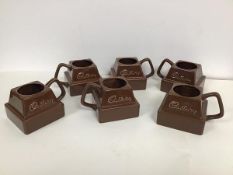 A set of six Cadbury Chocolate novelty mugs in the form of a square of chocolate with handle to side