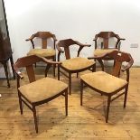 A set of five teak dining chairs, c.1970s, each with yoke shaped top rail and projecting arms, above