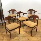 A set of five teak dining chairs, c.1970s, each with yoke shaped top rail and projecting arms, above