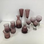 A selection of amethyst coloured glass including a carafe of bell form, four similar tulip shaped