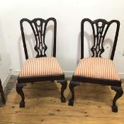 A pair of early 20thc Chippendale style side chairs, the carved top rail with a central pierced