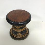 An Indian stool, the padded leather seat decorated with three dancing maidens, with an interlaced