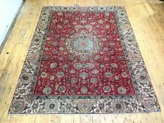 A North West Persian carpet, the red field allover decorated with interwoven flowerheads,