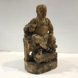 A Chinese carved wooden figure of a seated deity or dignitary, in the Ming style, possibly Zhenwu (