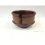 A mahogany table top plate stand or holder, circular, with moulded and turned bands. 17cm by 29.5cm