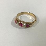 A five stone ruby and diamond ring, the three graduated round-cut rubies spaced by a pair of round