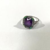 An amethyst, diamond and enamel dress ring, early 20th century, the central amethyst (10mm by 8mm)