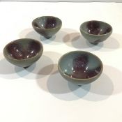 A set of four modern Chinese small bowls each with mottled celadon glaze, unmarked. (4) 5cm by 9cm
