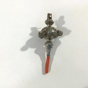 A late Victorian silver baby's rattle, Birmingham 1900, of characteristic form, suspending four