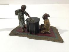 In the manner of Franz Bergman, a cold-painted bronze group of two North African boys playing dice