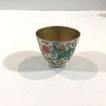 A Chinese porcelain tea bowl, decorated with an exotic beast and scrolling flowers above a lappet