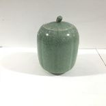 A Vietnamese celadon crackle-glazed pottery jar and cover, with ribbed body, unmarked. Height 19cm