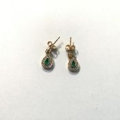 A pair of 18ct gold emerald and diamond drop earrings, of teardrop form, centred by a conforming