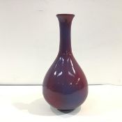 A Chinese porcelain vase in a sang-de-boeuf glaze, of flask form, mottled in red and lavender,