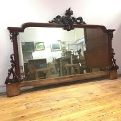 A large Victorian mahogany framed mirror, the shaped rectangular plate within a moulded frame,