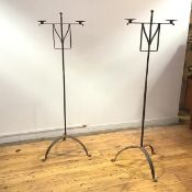 A pair of painted steel floor-standing candelabra, each turned shaft with ball finial and projecting