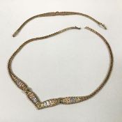 A 9ct tri-coloured gold necklace and bracelet en suite, each formed of white, rose and yellow gold