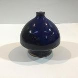 A Chinese blue glazed clay vase, of domed form, and tapering towards an unglazed base. Height 13.