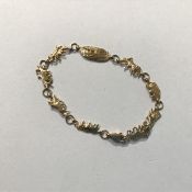 An unusual child's 10ct gold bracelet, the links modelled as Noah's ark with pairs of animals,