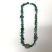 A turquoise pebble bead necklace, the stones of varying irregular shapes, on a barrel clasp.