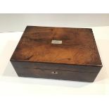 A Victorian mahogany work box, of plain rectangular form, the cover inlaid with a mother of pearl