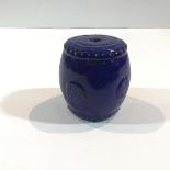 A Chinese blue-glazed pottery incense stick holder, of barrel form, with moulded decoration.
