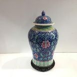A large Chinese porcelain jar and cover in a famille rose palette, of baluster form, with domed