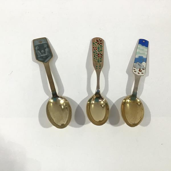 A group of three Danish sterling silver and enamel Christmas spoons by A. Michelsen, Copenhagen: