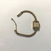 A lady's 9ct gold wristwatch, c. 1950, the square silvered dial with Arabic numerals, signed Tatton,