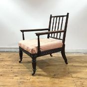 A Scottish Regency rosewood library chair, the tapered top rail and turned finials above a spindle