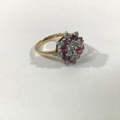 A ruby and diamond cluster ring, centred by a claw-set ruby within alternating bands of rubies and